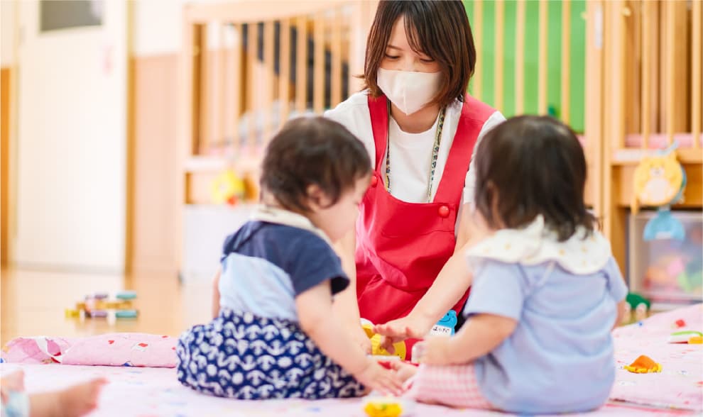 保育士と子どもが遊ぶ様子